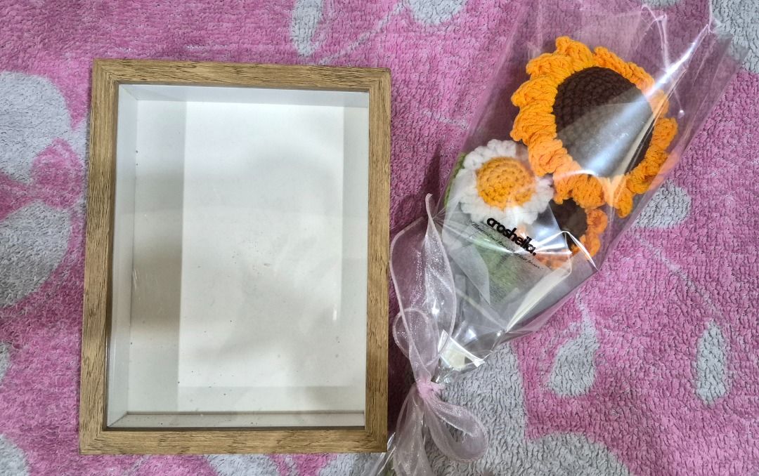 Crocheted Sunflower Bouquet with Wooden Frame (Category: Flowers & Bouquets) located in Manila. Submitted by fastdragon_0c367e (Listing ID 1454053928, Image 1). Description: - Handmade crocheted sunflower bouquet with a smaller white flower. - Includes a simple wooden frame (empty for your photo/artwork). - Beautifully wrapped in clear cellophane with a ribbon. - Perfect for home decor or as a thoughtful gift. - Adds a pop of color and handmade c
