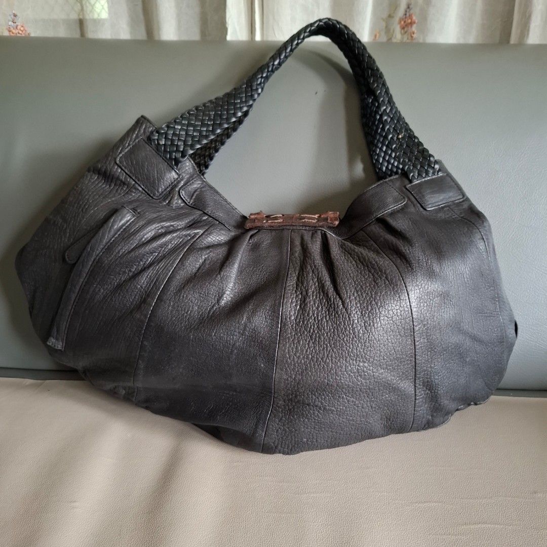 Dark Grey Leather Hobo Bag with Braided Straps (Category: Shoulder Bags) located in Don Carlos. Submitted by PphiXi_Finds (Listing ID 1454145686, Image 3). Description: - Cool black leather hobo bag - Braided straps for a stylish touch - Unique textured buckle detail on the front with crocodile skin leather flap - Black fabric interior lining - Interior zippered pocket for security - Interior slip pocket for easy access - Spacious enough for all 