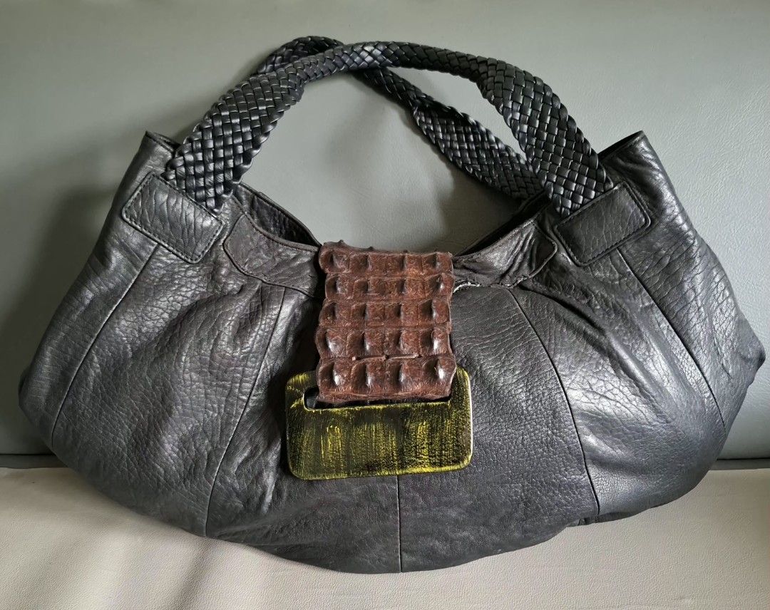 Dark Grey Leather Hobo Bag with Braided Straps (Category: Shoulder Bags) located in Don Carlos. Submitted by PphiXi_Finds (Listing ID 1454145686, Image 1). Description: - Cool black leather hobo bag - Braided straps for a stylish touch - Unique textured buckle detail on the front with crocodile skin leather flap - Black fabric interior lining - Interior zippered pocket for security - Interior slip pocket for easy access - Spacious enough for all 