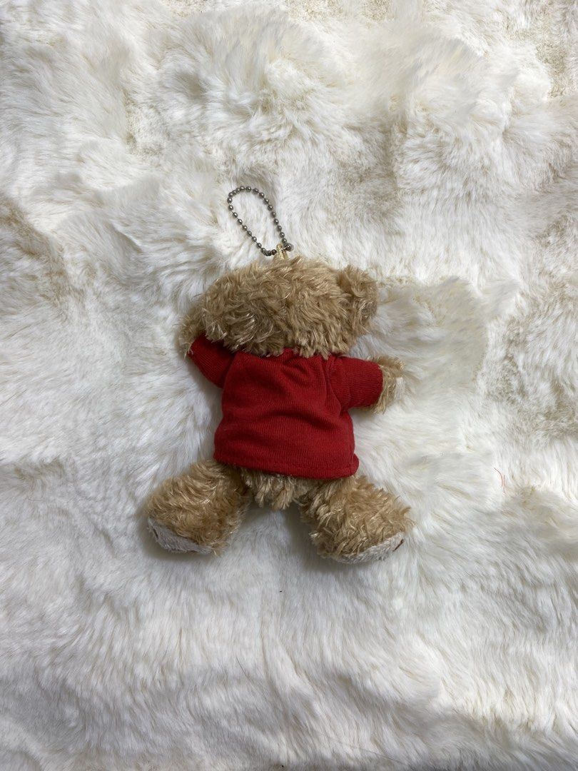 Duffy Bear Plush Charm/Keychain with Red Shirt (Category: Plushies & Soft Toys) located in Kalibo. Submitted by ollie_stuffshop (Listing ID 1454027947, Image 2). Description: Before you send your inquiries: ❗️Last Price is already posted ❗️Manage your expectations, WYSIWYG ❗️May need washing ❗️Shipping day is every Sunday - Adorable bear plushie - Comes with a keychain attachment - Features a red shirt with a blue emblem - Ideal for decorating ba