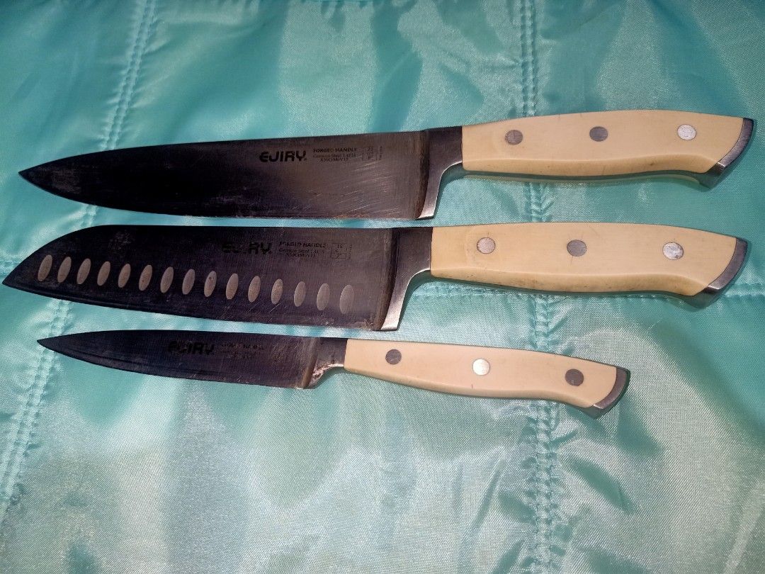 EJIRY Forged Handle Kitchen Knives Set - German Steel (Category: Knives & Chopping Boards) located in Pasig City. Submitted by urdal01 (Listing ID 1454129669, Image 3). Description: - Set of 3 EJIRY kitchen knives - Includes: Chef's knife, Santoku knife (with air holes), Paring knife - Material: German steel blades, forged handles - Condition: Blades are sharp with some signs of use - Handle color: Light cream - Ideal for: Everyday cooking.