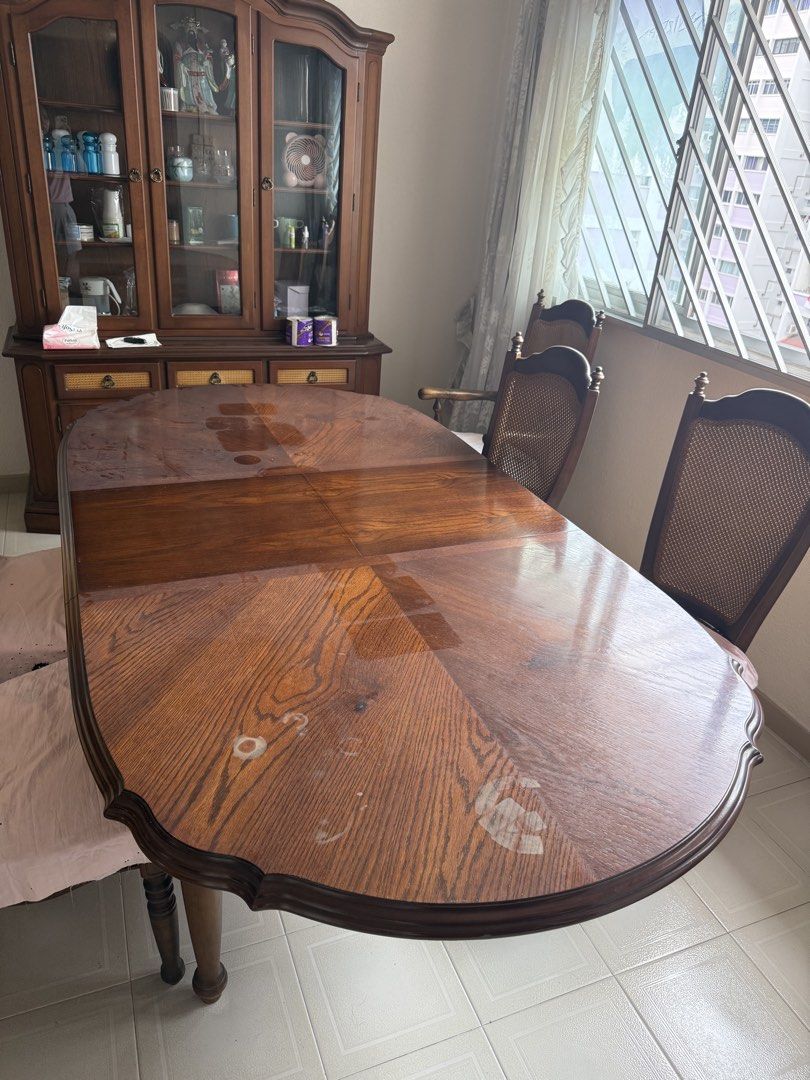 Extendable solid wood table (Category: Tables & Sets) located in Singapore. Submitted by i.am.a.genius (Listing ID 1454047065, Image 1). Description: Extendable from 1.68m to 2.14m 6 solid wood chairs with cushions. You will need to reupholster it yourself. Varnish the table to achieve the deep wood look at the centre. Dining chairs have rattan backing all in good condition. .
