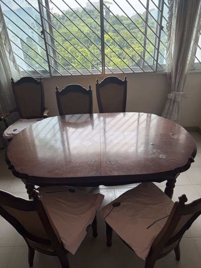 Extendable solid wood table (Category: Tables & Sets) located in Singapore. Submitted by i.am.a.genius (Listing ID 1454047065, Image 2). Description: Extendable from 1.68m to 2.14m 6 solid wood chairs with cushions. You will need to reupholster it yourself. Varnish the table to achieve the deep wood look at the centre. Dining chairs have rattan backing all in good condition. .