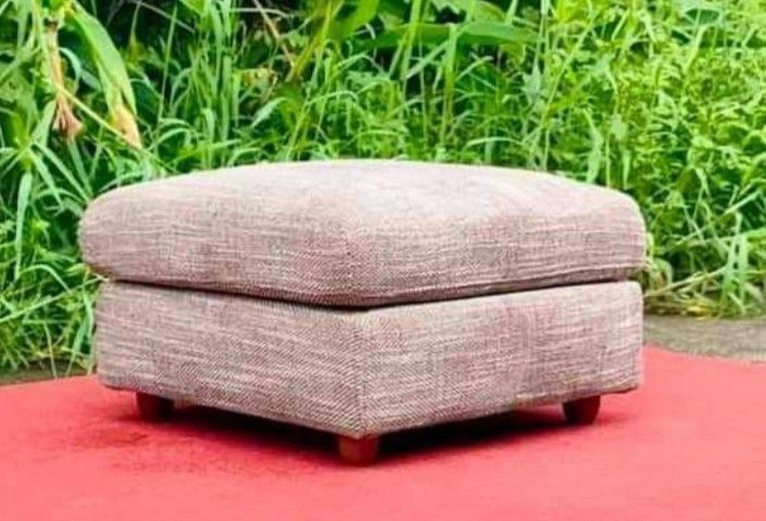 Fabric Ottoman Footrest Stool (Category: Chairs) located in Quezon City. Submitted by annienc (Listing ID 1454003323, Image 1). Description: - Square fabric ottoman in neutral beige/brown textured fabric - Adds comfort and versatility to any living space - Can be used as a footrest or extra seating. - Features sturdy wooden legs - Removable covers - Dimensions: 24 x 24 x 16 inches (LWH) .