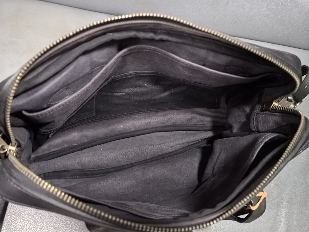 Filson 2-Way Bag Cinder (Category: Briefcases) located in Cagayan de Oro. Submitted by pootx (Listing ID 1454145526, Image 3). Description: - Filson Briefcase in Cinder color - Made in USA - Crafted from 100% Cotton and Cow Leather - Features durable Brass Hardware - Main zippered compartment with internal pockets - Additional external pocket for quick access - Versatile carrying options: top handles or adjustable shoulder strap - Ideal for both 