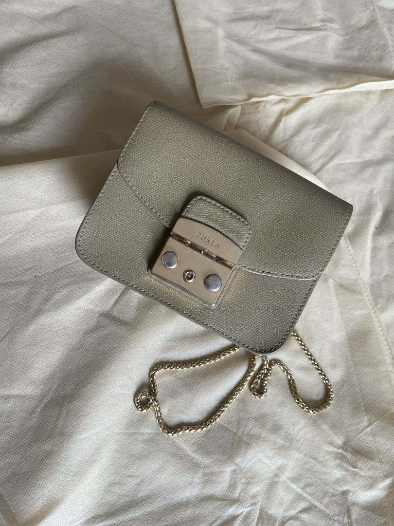 Furla Metropolis Mini Crossbody Bag (Category: Luxury Bags & Wallets) located in Bulacan. Submitted by bella.ken.varietystore (Listing ID 1454069288, Image 2). Description: - Cute Furla Metropolis mini bag - Lovely light greyish-green color - Gold chain strap - Secure clasp closure - Ideal for carrying essentials - Comes with original dust bag.