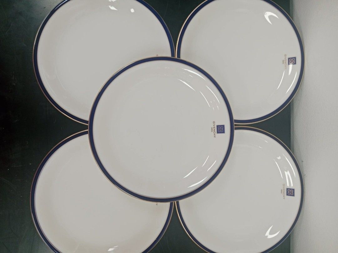 Givenchy dinner plates (Category: Dinnerware & Cutlery) located in San Pedro. Submitted by thriftersp47808 (Listing ID 1454137283, Image 2). Description: This is an authentic Givenchy Paris porcelain dinnerware plate, manufactured in Japan under official license by Yamaka International. [1, 2] Design Details Pattern: Classic white porcelain center accented with a distinct dark cobalt blue and thin gold trim along the rim. Logo Branding: Features 