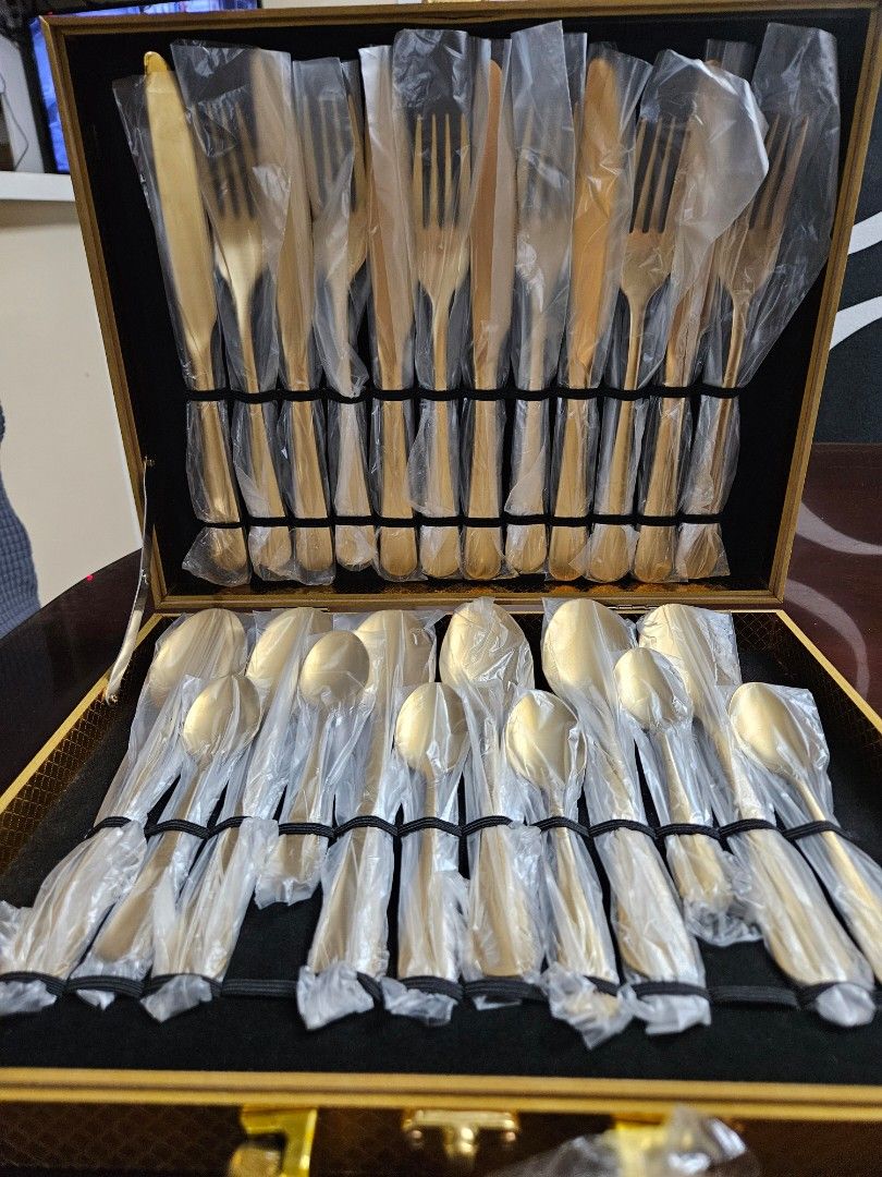 Gold Cutlery Set in Presentation Box (Category: Dinnerware & Cutlery) located in Caloocan City. Submitted by rm.diaz (Listing ID 1454021214, Image 1). Description: - Beautiful gold cutlery set - Includes spoons, forks, knives, and teaspoons ( 24 pcs) - All pieces individually wrapped in plastic - Comes in a sturdy, textured gold presentation box with a handle - Ideal for special occasions or as a gift - Box features a secure latch.
