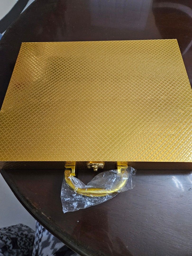Gold Cutlery Set in Presentation Box (Category: Dinnerware & Cutlery) located in Caloocan City. Submitted by rm.diaz (Listing ID 1454021214, Image 2). Description: - Beautiful gold cutlery set - Includes spoons, forks, knives, and teaspoons ( 24 pcs) - All pieces individually wrapped in plastic - Comes in a sturdy, textured gold presentation box with a handle - Ideal for special occasions or as a gift - Box features a secure latch.