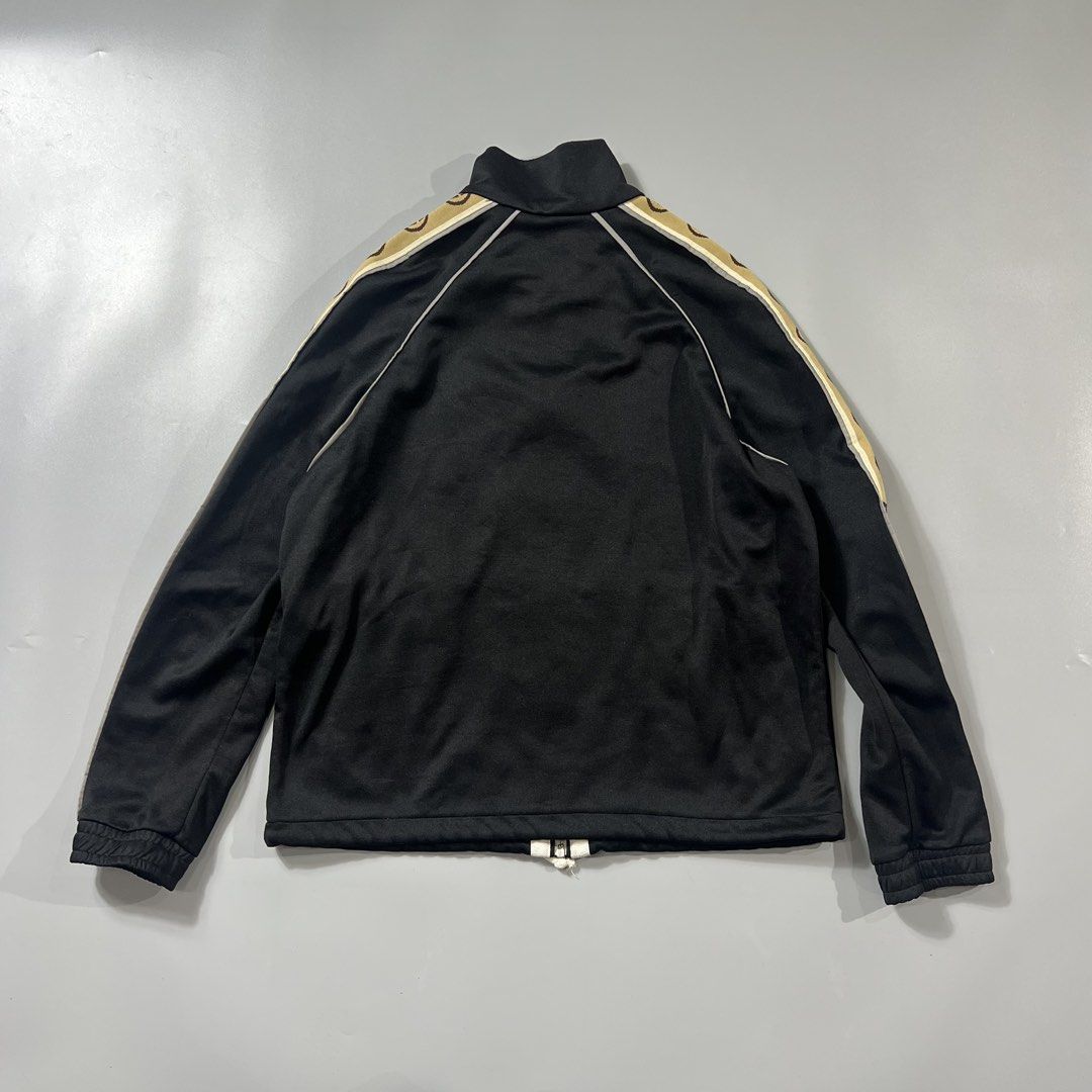 Gucci GG Track Jacket (Category: Coats, Jackets and Outerwear) located in Baguio. Submitted by pinkpixie (Listing ID 1454153876, Image 2). Description: - Iconic GG monogram stripe down the sleeves - Zip-up front with stand-up collar - Two side pockets with zippers - Made in Italy - Ideal for casual wear or athleisure.
