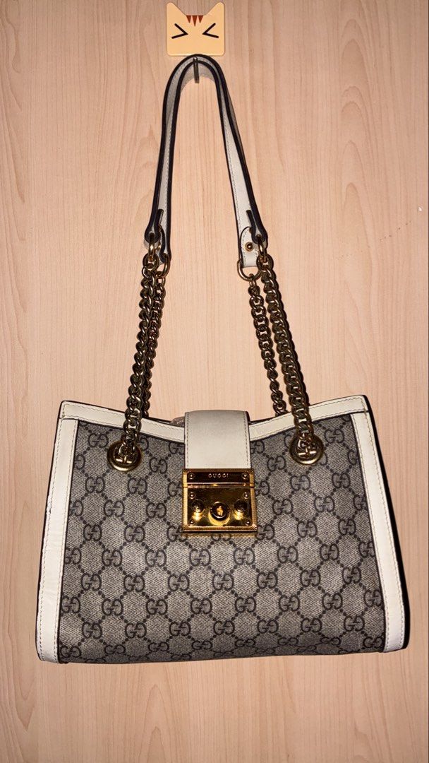 Gucci Padlock GG Supreme Canvas Shoulder Bag (Category: Luxury Bags & Wallets) located in Placer. Submitted by talaalond61563 (Listing ID 1454127630, Image 1). Description: - Gucci Padlock Tote Bag - Classic GG Supreme canvas with white leather trim - Gold-tone hardware and chain strap - Secure lock closure with Gucci engraving - Made in Italy - Serial number: 498156 6368.