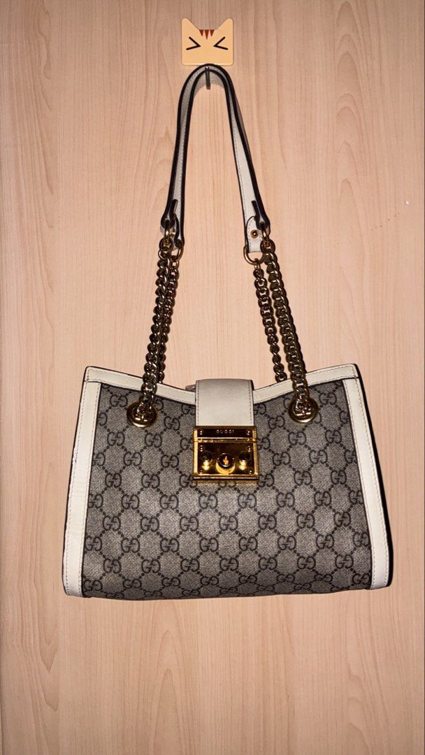 Gucci Padlock GG Supreme Canvas Shoulder Bag (Category: Luxury Bags & Wallets) located in Placer. Submitted by talaalond61563 (Listing ID 1454127630, Image 2). Description: - Gucci Padlock Tote Bag - Classic GG Supreme canvas with white leather trim - Gold-tone hardware and chain strap - Secure lock closure with Gucci engraving - Made in Italy - Serial number: 498156 6368.