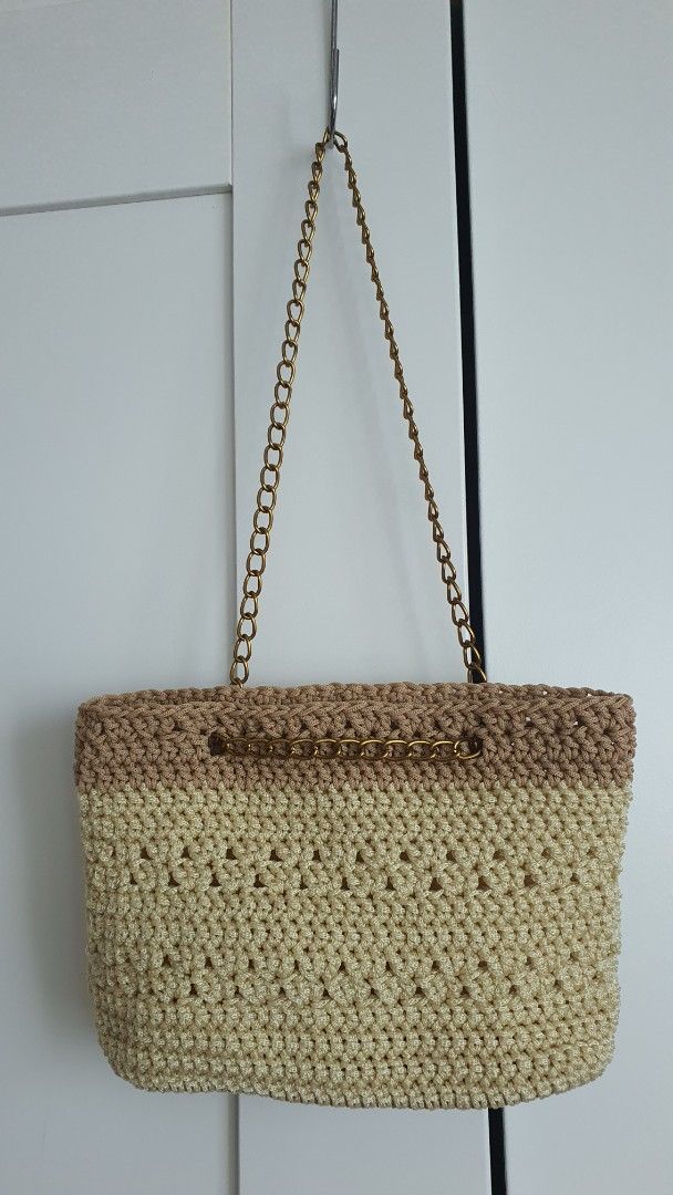 Handmade Crocheted Bag with Chain Strap (Category: Purses & Pouches) located in Quezon City. Submitted by celestial_matters (Listing ID 1454098751, Image 2). Description: - Cute handmade crochet purse or clutch - Beige and brown color combination - Features a stylish gold chain strap - Intricate and unique crochet pattern - Spacious interior for your essentials - Ideal for cocktail events or as a statement accessory - bottom : 6.5" long & 1.75" w