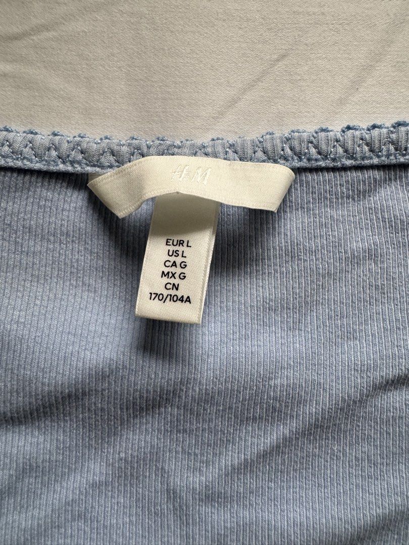 H&M Light Blue Ruched V-Neck Long Sleeve Top (Category: Longsleeves) located in Manila. Submitted by calmphoenix.7846bf (Listing ID 1454052683, Image 2). Description: - Cute light blue long-sleeve top from H&M - V-neck with front ruching detail - Lettuce edge hem and cuffs - Ribbed material for a comfortable fit - Versatile: pairs well with jeans or skirts, easy to dress up or down.