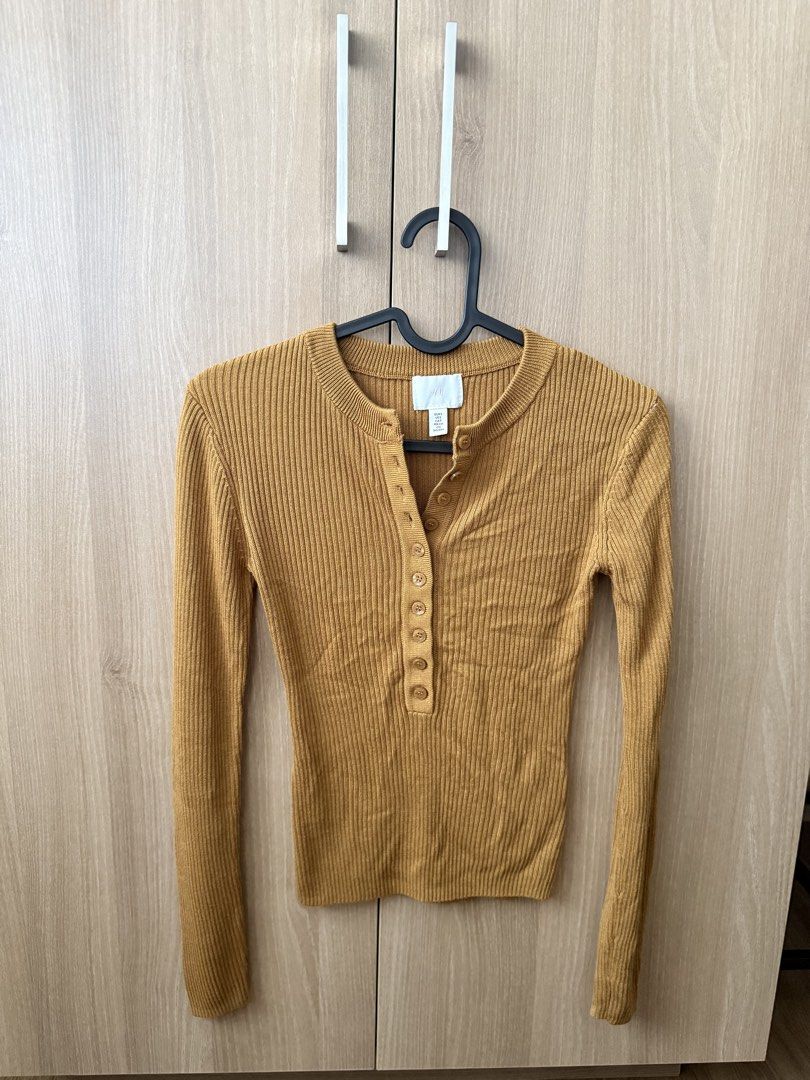 H&M Mustard Yellow Ribbed Button Up Long Sleeve Top (Category: Longsleeves) located in Tuguegarao City. Submitted by Jarah (Listing ID 1454079261, Image 1). Description: - Mustard yellow long sleeve top - Brand: H&M - Material: Ribbed knit - Features: Button-up neckline - Versatile: Great for layering or wearing alone - Style: Comfortable and stylish for everyday wear - fits xs to small frames.