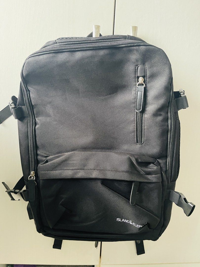 Island Elephant Travel Backpack (Category: Backpacks) located in Manila. Submitted by ttbbkk (Listing ID 1454013514, Image 2). Description: - Island Elephant black backpack - Multiple compartments for organized storage - Includes main bag, phone bag, power bank bag, and pencil case slots - Front zippered pocket and vertical zippered pocket - Luggage strap for attaching to trolley cases - Side tote pocket for quick access items - Comfortable honey