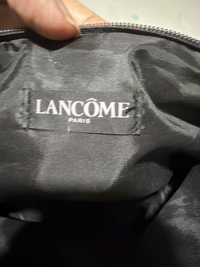 Lancome Paris Cosmetic Bag with Eiffel Tower Charm (Category: Makeup) located in Las Pinas. Submitted by ces0427 (Listing ID 1454187005, Image 3). Description: - Cute makeup pouch from Lancome Paris. - Features a dark brown exterior. - Adorned with fun Paris-themed charms: Eiffel Tower, rose, and high heel. - Secure zipper closure. - Interior displays the Lancome Paris label. - Ideal for travel or everyday use to keep essentials organized..
