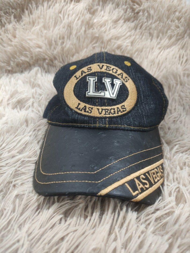 Las Vegas LV Denim Baseball Cap (Category: Caps & Hats) located in Manila. Submitted by shellys_collection (Listing ID 1454151303, Image 1). Description: - Stylish denim cap with "LV" and "Las Vegas" embroidery. - Features a black brim with elegant gold stitching. - Crafted from 100% Cotton for comfort. - Adjustable strap at the back ensures a perfect fit. - "Made in China" label. - Ideal for everyday casual wear..