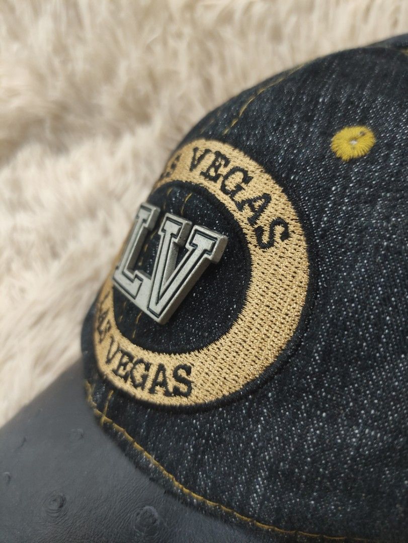 Las Vegas LV Denim Baseball Cap (Category: Caps & Hats) located in Manila. Submitted by shellys_collection (Listing ID 1454151303, Image 3). Description: - Stylish denim cap with "LV" and "Las Vegas" embroidery. - Features a black brim with elegant gold stitching. - Crafted from 100% Cotton for comfort. - Adjustable strap at the back ensures a perfect fit. - "Made in China" label. - Ideal for everyday casual wear..