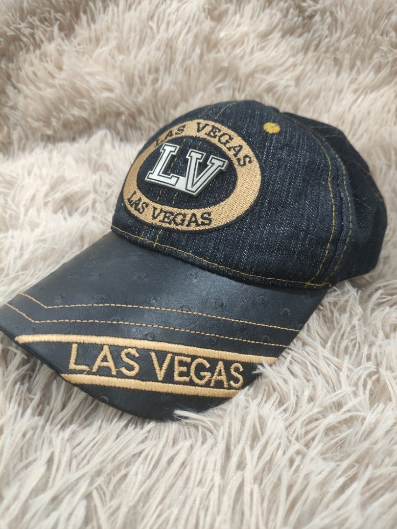 Las Vegas LV Denim Baseball Cap (Category: Caps & Hats) located in Manila. Submitted by shellys_collection (Listing ID 1454151303, Image 2). Description: - Stylish denim cap with "LV" and "Las Vegas" embroidery. - Features a black brim with elegant gold stitching. - Crafted from 100% Cotton for comfort. - Adjustable strap at the back ensures a perfect fit. - "Made in China" label. - Ideal for everyday casual wear..