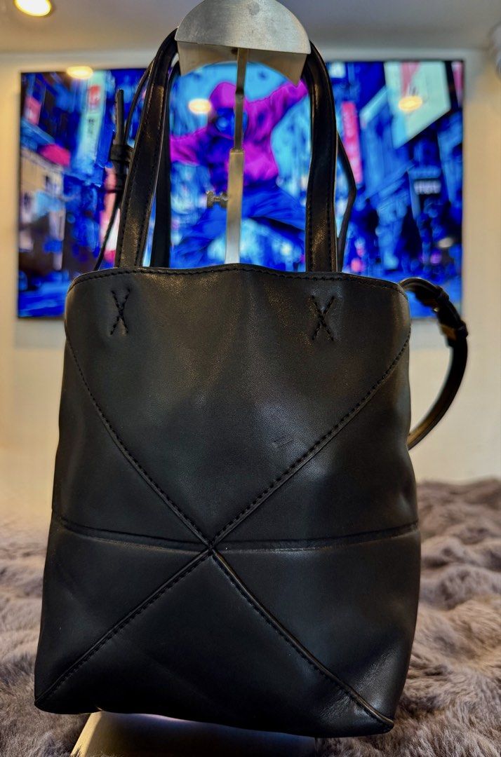 Leowe Puzzle Fold (Category: Cross-body Bags) located in Manila. Submitted by source.selection (Listing ID 1454097751, Image 3). Description: This black Loewe Puzzle Fold Tote Mini is crafted from grained calfskin and features signature geometric paneling with a gold-embossed logo..