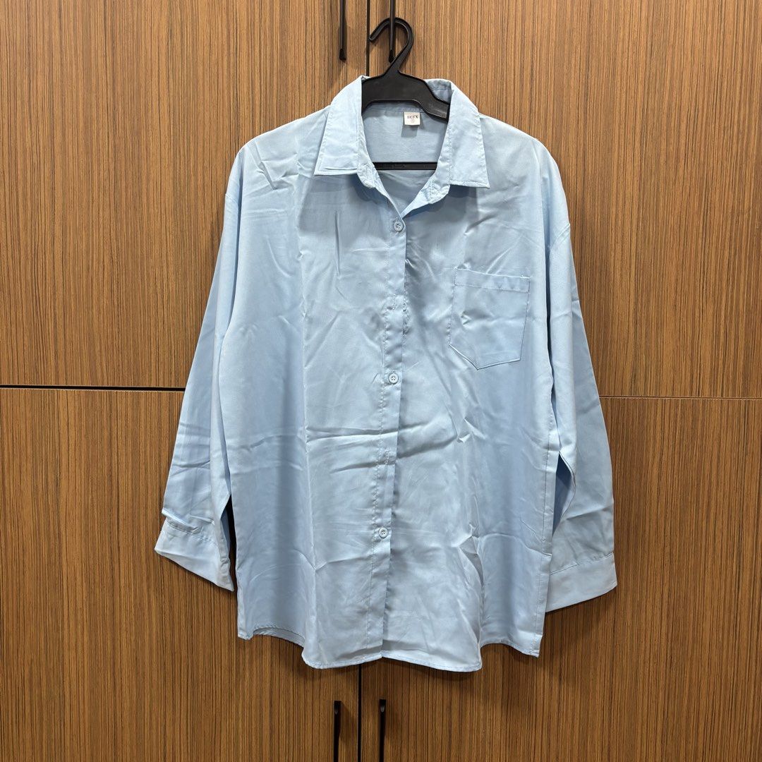 Light Blue Cotton Button-Up Shirt (Category: Tshirts & Polo Shirts ) located in Manila. Submitted by inationg (Listing ID 1454094518, Image 1). Description: - Classic light blue button-up shirt - Single chest pocket on the left - Material has a slight sheen - Long sleeves with button cuffs - Simple and versatile design, perfect for dressing up or down.