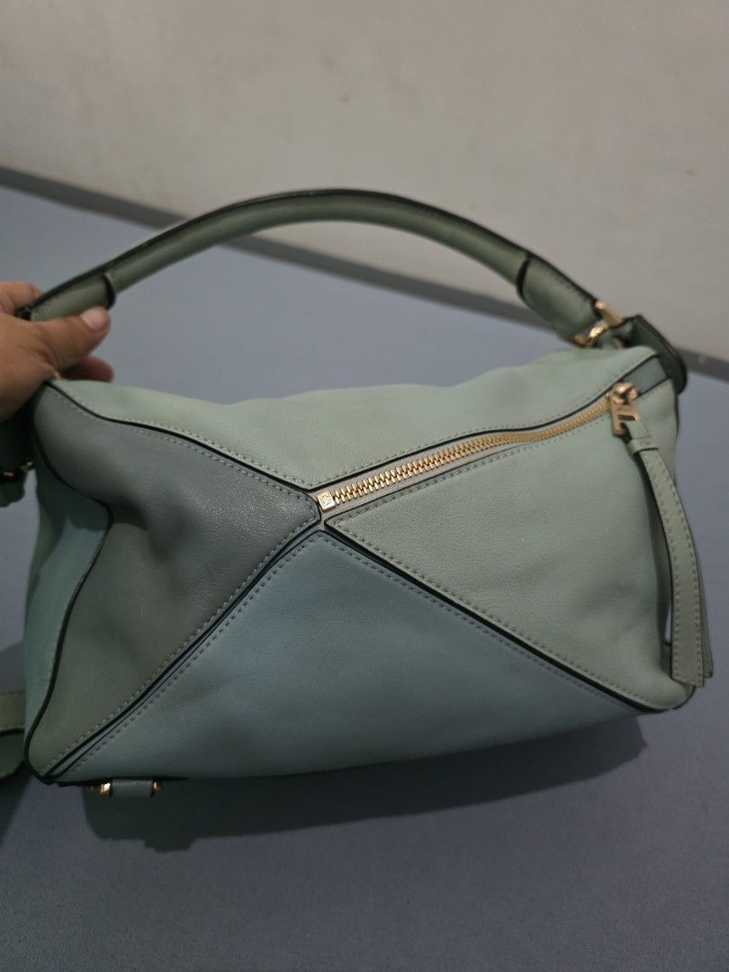 Loewe Puzzle Bag - Mint Green Leather (Category: Luxury Bags & Wallets) located in Lemery. Submitted by venus23 (Listing ID 1454087775, Image 2). Description: - Loewe Puzzle Bag - Color: Mint Green - Material: Genuine Leather - Iconic geometric panel design - Gold hardware - Top handle and shoulder strap - Versatile for everyday or special occasions - Note: Shows some signs of wear on the handle and edges.