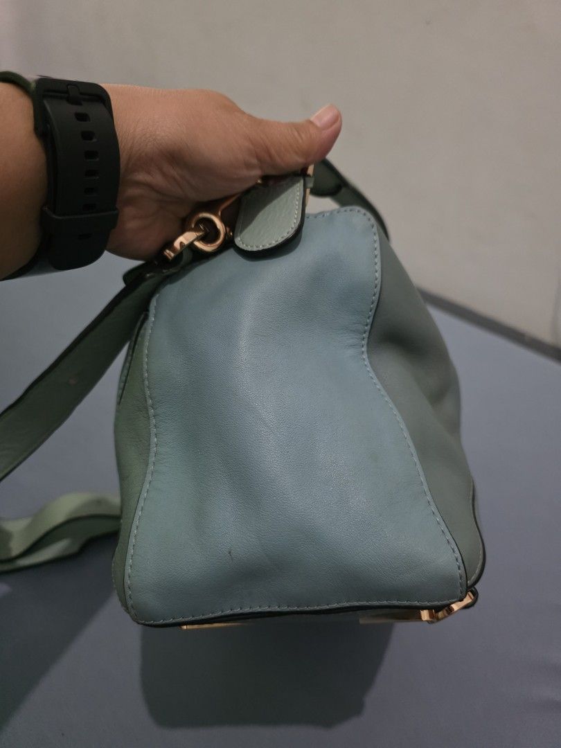 Loewe Puzzle Bag - Mint Green Leather (Category: Luxury Bags & Wallets) located in Lemery. Submitted by venus23 (Listing ID 1454087775, Image 3). Description: - Loewe Puzzle Bag - Color: Mint Green - Material: Genuine Leather - Iconic geometric panel design - Gold hardware - Top handle and shoulder strap - Versatile for everyday or special occasions - Note: Shows some signs of wear on the handle and edges.
