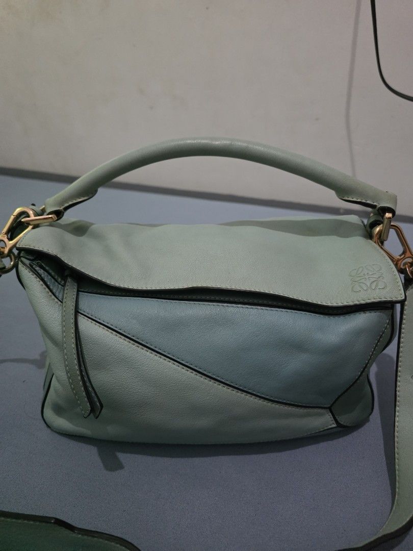 Loewe Puzzle Bag - Mint Green Leather (Category: Luxury Bags & Wallets) located in Lemery. Submitted by venus23 (Listing ID 1454087775, Image 1). Description: - Loewe Puzzle Bag - Color: Mint Green - Material: Genuine Leather - Iconic geometric panel design - Gold hardware - Top handle and shoulder strap - Versatile for everyday or special occasions - Note: Shows some signs of wear on the handle and edges.