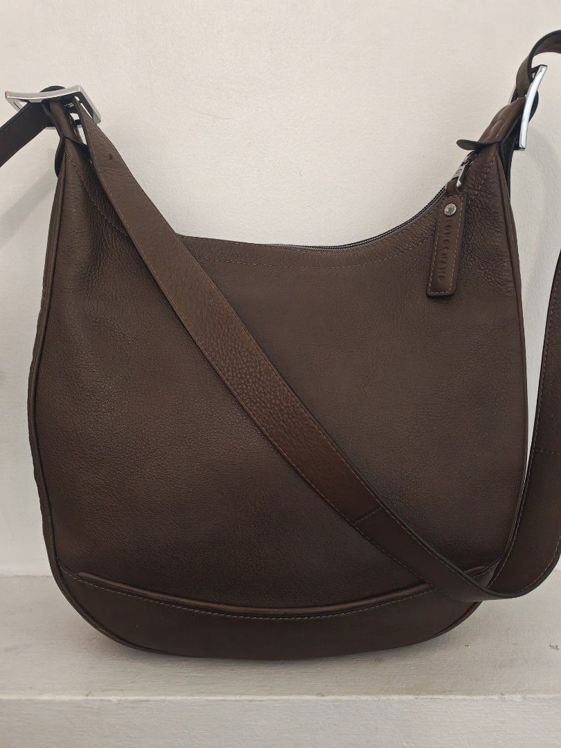 Longchamp Cosmos Sac leather bag (Category: Luxury Bags & Wallets) located in Quezon City. Submitted by destashingme (Listing ID 1454087296, Image 2). Description: measures : 16 inches wide x 12 at its lowest zipper point. strap is adjustable. It is in excellent condition. no rips or marks. - Authentic Brown Leather Longchamp Hobo Bag - Textured leather finish for a sophisticated look - Convenient front zipper pocket for essentials - Adjustable s