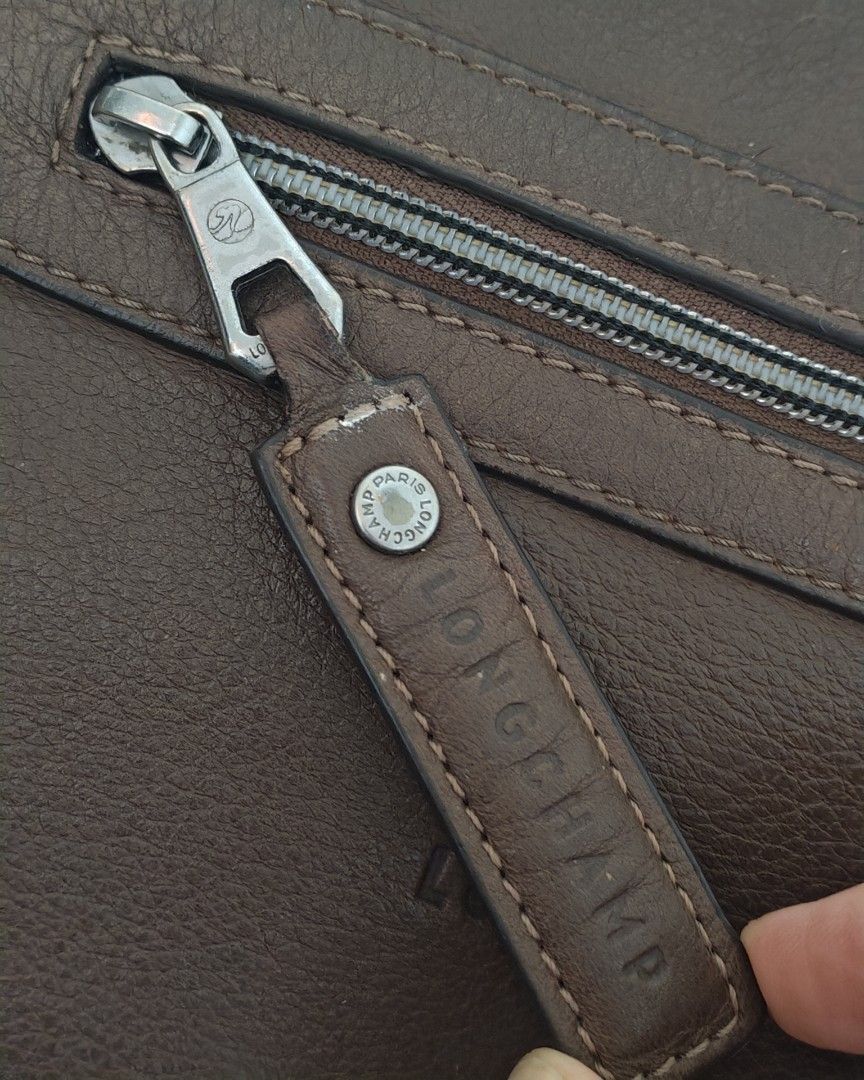 Longchamp Cosmos Sac leather bag (Category: Luxury Bags & Wallets) located in Quezon City. Submitted by destashingme (Listing ID 1454087296, Image 3). Description: measures : 16 inches wide x 12 at its lowest zipper point. strap is adjustable. It is in excellent condition. no rips or marks. - Authentic Brown Leather Longchamp Hobo Bag - Textured leather finish for a sophisticated look - Convenient front zipper pocket for essentials - Adjustable s