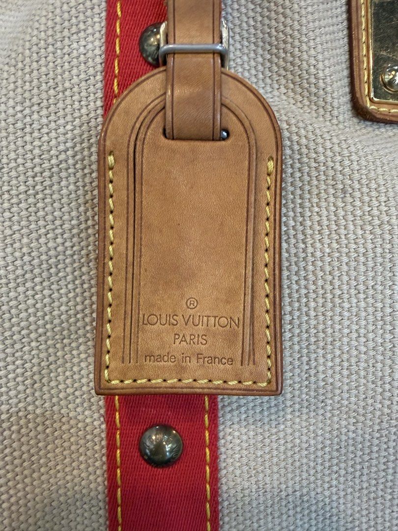 Louis Vuitton Antigua Cabas GM (Category: Tote Bags) located in Manila. Submitted by source.selection (Listing ID 1454084417, Image 2). Description: This Louis Vuitton Antigua Cabas GM tote bag features beige canvas with red strap details and a gold-tone brass plaque..