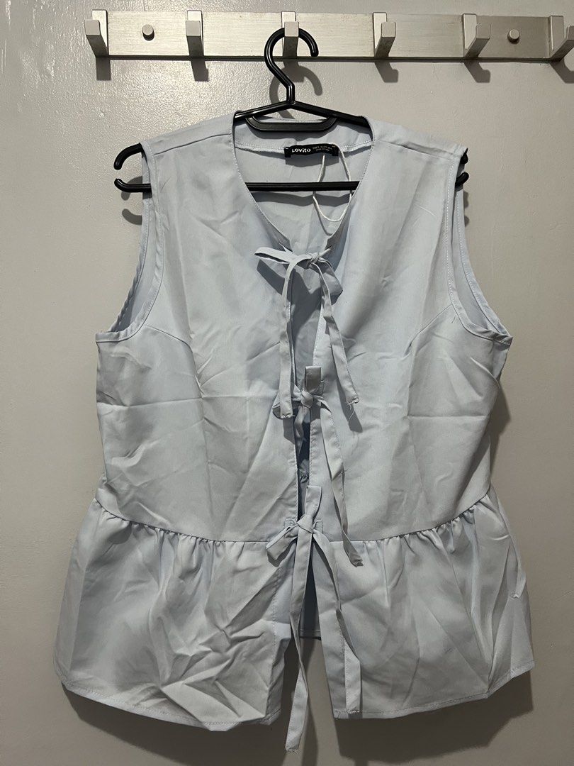 Lovito Light Blue Sleeveless Peplum Tie Front Top (Category: Sleeveless) located in Manila. Submitted by justppatterns (Listing ID 1454133307, Image 1). Description: - Lovito light blue sleeveless top - Features a tie-front detail - Flattering peplum hem - V-neckline - Can be tied at the back for adjustable fit - Perfect for layering or wearing solo - Easy to style for casual or dressy occasions.
