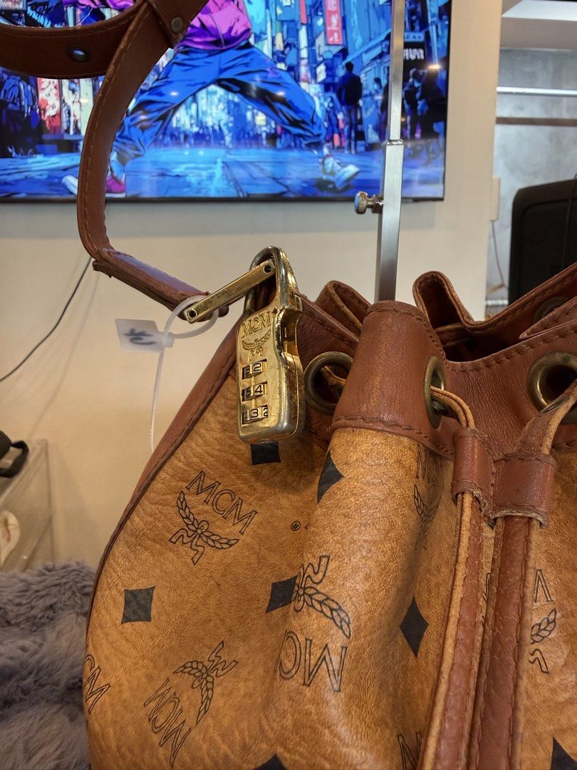 MCM Visetos monogram bucket (Category: Sling Bags) located in Manila. Submitted by source.selection (Listing ID 1454094375, Image 3). Description: This MCM Visetos monogram bucket bag in cognac leather features a distinctive gold-toned logo plate..