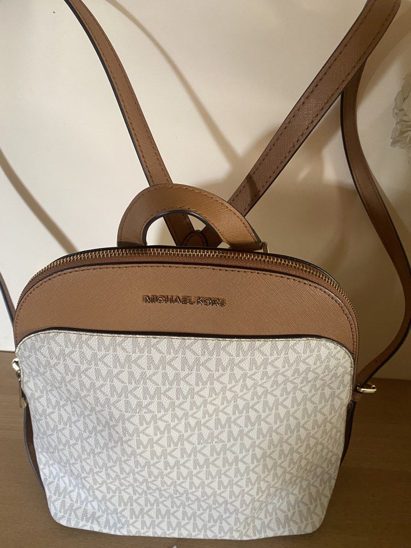 Michael Kors Signature Logo Backpack (Category: Backpacks) located in Iloilo. Submitted by myprelovedcloset3 (Listing ID 1454071935, Image 3). Description: - Authentic Michael Kors backpack - Signature MK print with tan leather trim - Top handle and adjustable shoulder straps - Gold hardware details - Includes care cards - Ideal for everyday use.