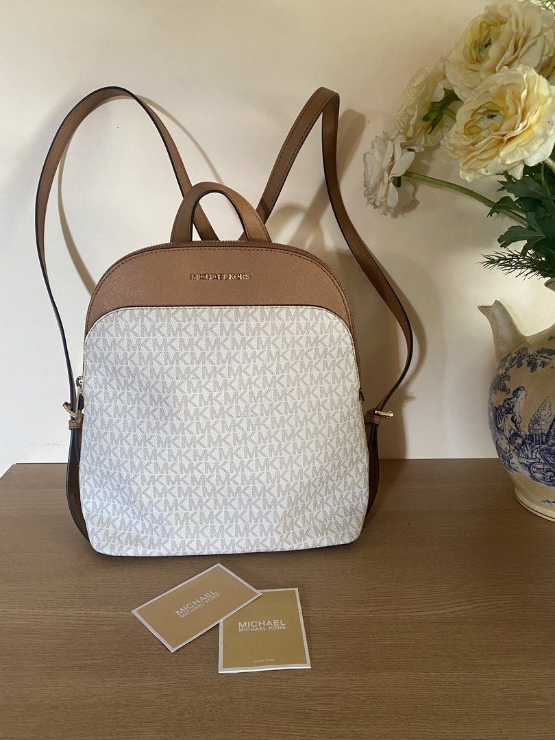 Michael Kors Signature Logo Backpack (Category: Backpacks) located in Iloilo. Submitted by myprelovedcloset3 (Listing ID 1454071935, Image 2). Description: - Authentic Michael Kors backpack - Signature MK print with tan leather trim - Top handle and adjustable shoulder straps - Gold hardware details - Includes care cards - Ideal for everyday use.