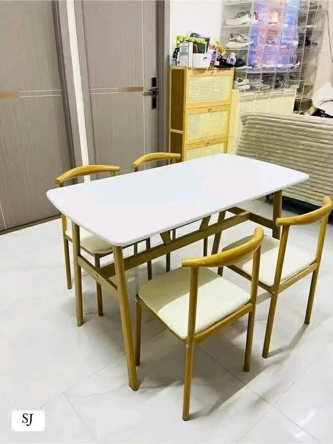 Modern Dining Table and Chairs Set (Category: Tables & Sets) located in Mandaluyong City. Submitted by carmy.94 (Listing ID 1454006047, Image 2). Description: - Compact dining set ideal for small spaces like apartments or breakfast nooks. - Includes one rectangular table with a stylish wood-look finish. - Comes with four chairs featuring comfortable cushioned seats. - Comfortably seats up to four people. - Simple and easy assembly process..