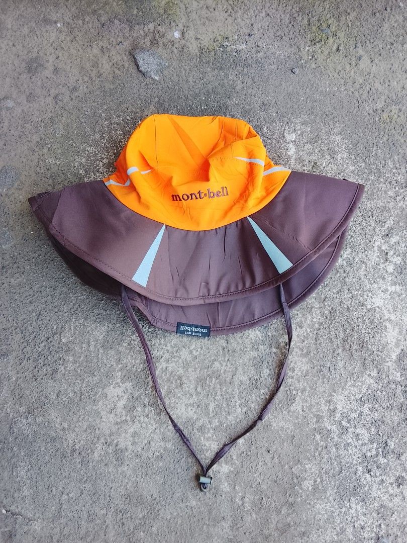 Mont-bell Bucket Hat (Category: Caps & Hats) located in Salay. Submitted by kenzmisael55555 (Listing ID 1454116883, Image 2). Description: - Mont-bell bucket hat - Color: Orange top with brown brim - Adjustable chin strap for a secure fit - Ideal for outdoor activities - Reflective details on top for visibility - Provides excellent sun protection.