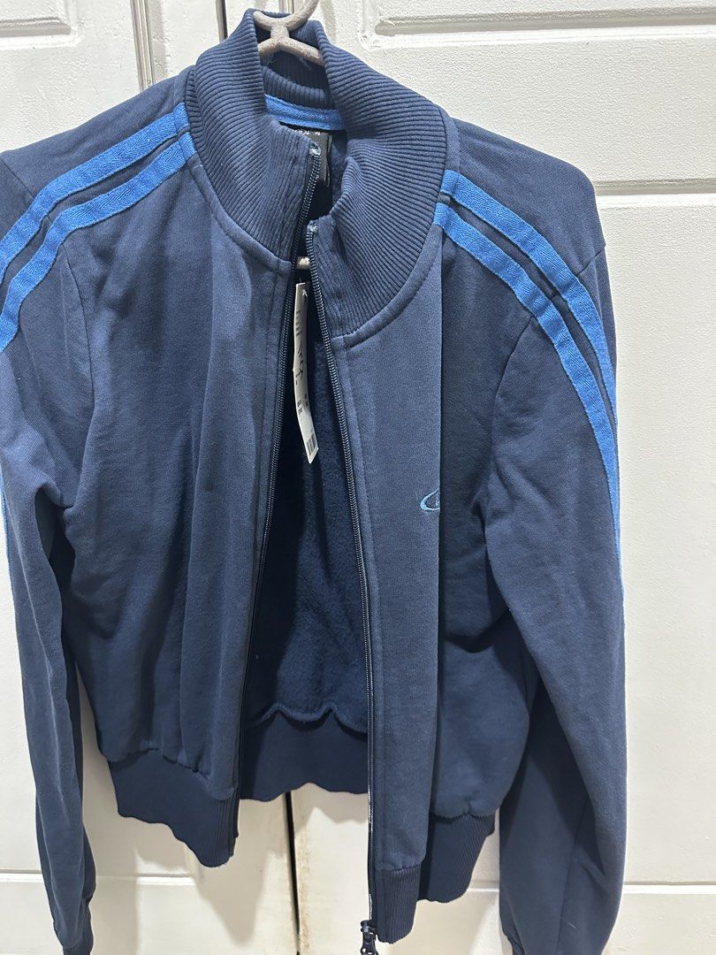 Navy Blue Track Jacket with Blue Stripes (Category: Coats, Jackets and Outerwear) located in Malolos. Submitted by erickanuggets (Listing ID 1454179918, Image 1). Description: - Navy blue track jacket - Features blue stripes on sleeves - Full zipper closure - Ribbed cuffs and hem for a snug fit - Ideal for casual wear.