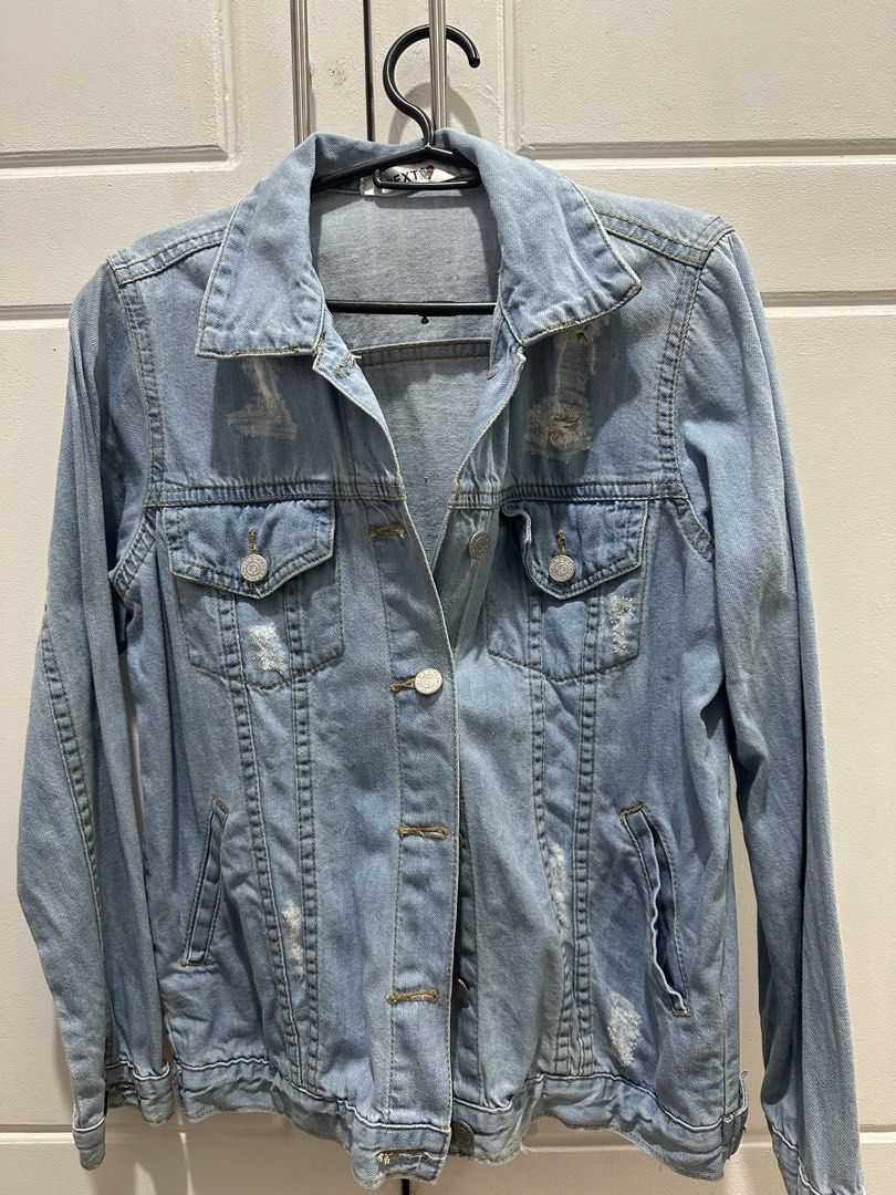 NEXT Light Wash Distressed Denim Jacket (Category: Coats, Jackets and Outerwear) located in Malolos. Submitted by erickanuggets (Listing ID 1454179841, Image 1). Description: - Brand: NEXT - Style: Light wash denim jacket - Features: Classic collar, button-up front - Details: Distressed pockets and sleeves for an edgy look - Versatility: Great for layering over any outfit for a casual style.