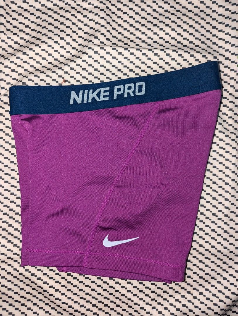 Nike Pro Purple Compression Shorts (Category: Activewear) located in Manila. Submitted by booksandbeyond (Listing ID 1454020195, Image 2). Description: - Purple Nike Pro compression shorts - Elastic waistband with Nike Pro branding - Small Nike swoosh logo on the side - Ideal for workouts and sports - Provides a comfortable and supportive fit.