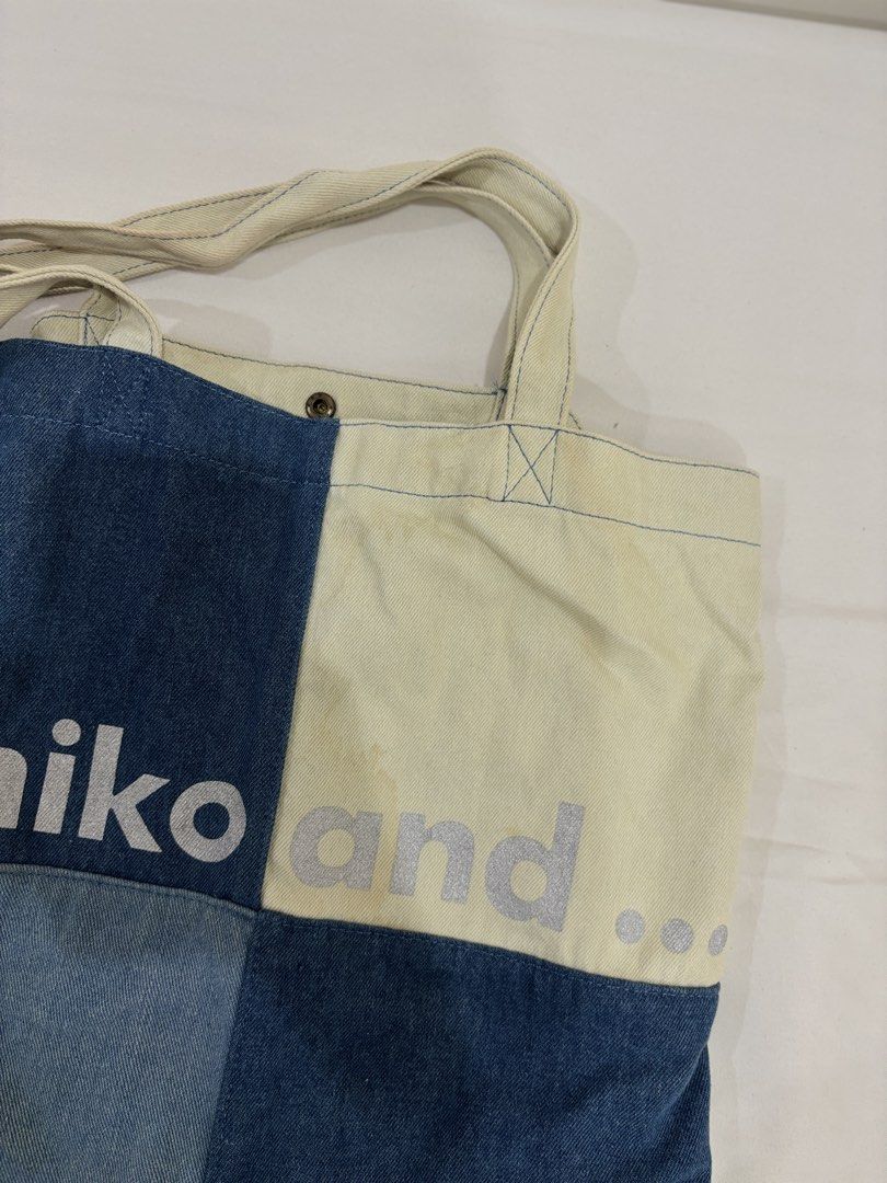 Niko and... Denim and Canvas Patchwork Tote Bag (Category: Tote Bags) located in Marikina City. Submitted by beadc (Listing ID 1454160544, Image 3). Description: - Cool patchwork tote bag from Niko and... - Mix of denim and canvas materials - Features a snap button closure - Includes an inner pocket - Ideal for everyday use - minor stain.