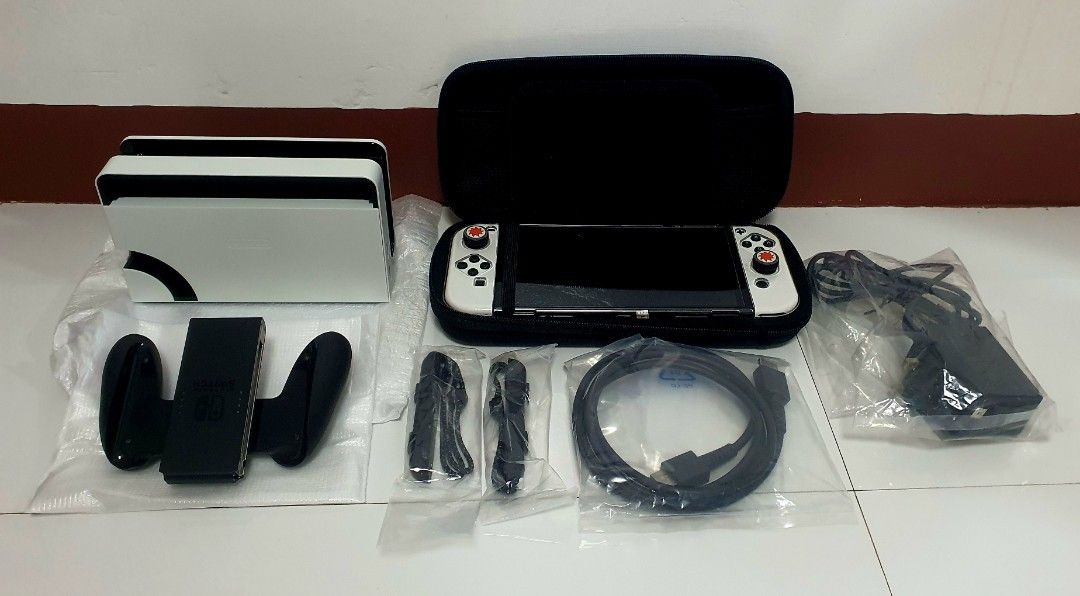 Nintendo Switch OLED White Console with Accessories (Category: Nintendo) located in Las Pinas. Submitted by elyladdaran09 (Listing ID 1454109559, Image 1). Description: PRICE: 9,799 Nintendo Switch OLED Model (White) Naka tempered since day 1 64gb internat memory Includes original dock Comes with Joy-Cons Protective Hard Case & Nintendo Pouch All original cables included complete package and accessories. NO BOX natapon na. Has minimal sign of usa
