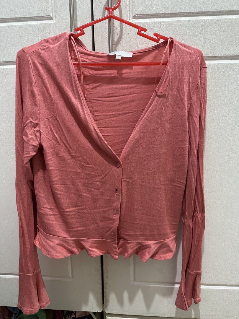 Pink Button-Up Cardigan with Ruffle Hem (Category: Coats, Jackets and Outerwear) located in Malolos. Submitted by erickanuggets (Listing ID 1454179940, Image 1). Description: - Adorable pink V-neck cardigan - Button-up front closure - Long sleeves with flared cuffs - Flirty ruffle detail along the hem - Made from soft, stretchy material - Ideal for layering over tops or dresses.