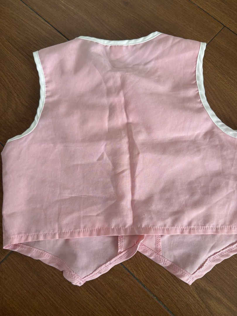 Pink Coquette Vest with Pearl Buttons (Category: Babies & Kids Fashion) located in Bulacan. Submitted by emjay_17 (Listing ID 1454052155, Image 2). Description: - Cute pink baby vest - White trim around edges - Four white bows on the front - Three pearl-like buttons down the middle - Toddler size - Ideal for dressing up or special occasions - Plain pink back.