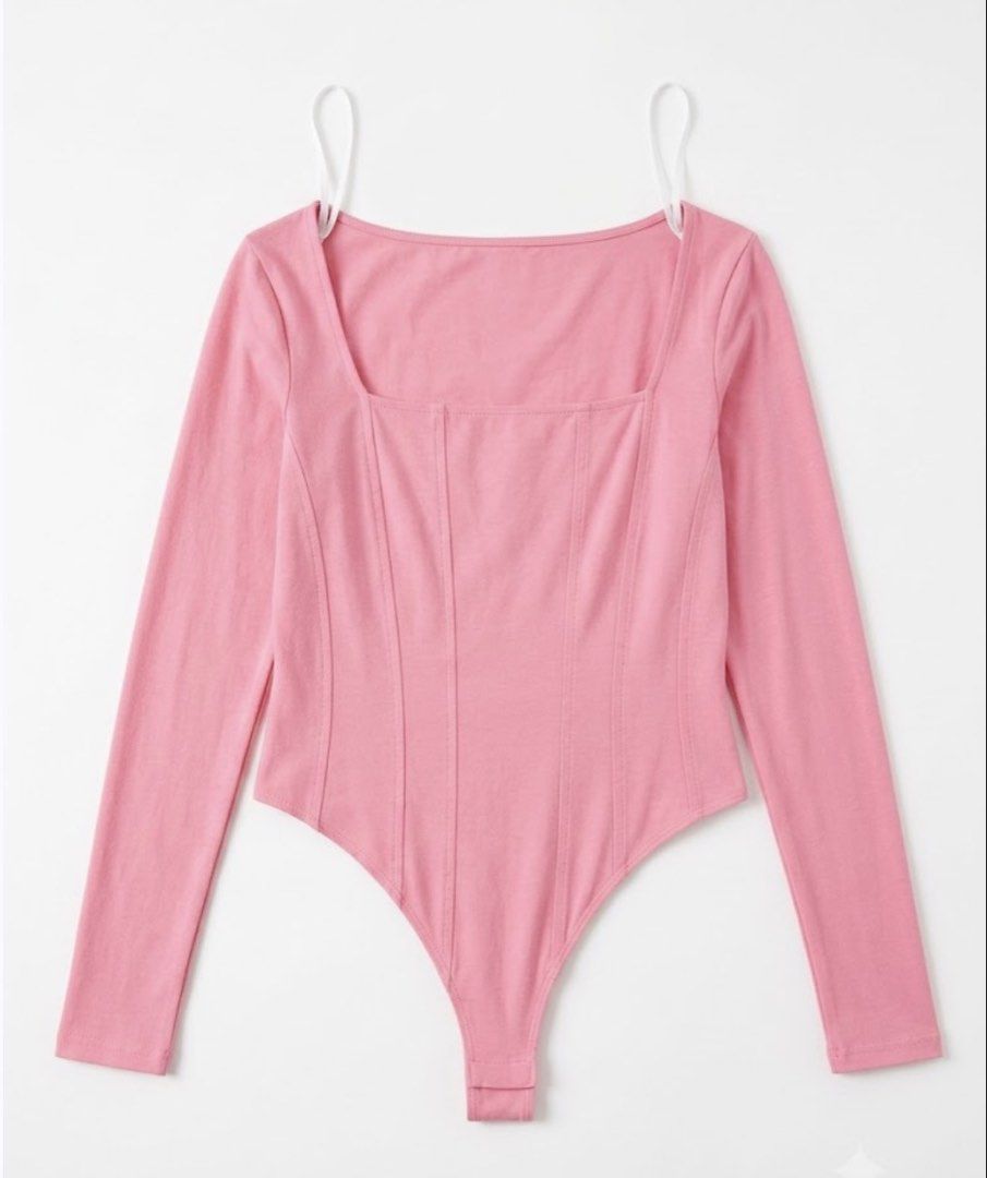 Pink Square Neck Long Sleeve Corset Bodysuit (Category: Others Tops) located in Manila. Submitted by sellerc362 (Listing ID 1454129694, Image 1). Description: Adorable pink long-sleeved bodysuit, flattering square neckline with a corset-style front with vertical seams for a cinched look. CONDITION: No stains, No damages .