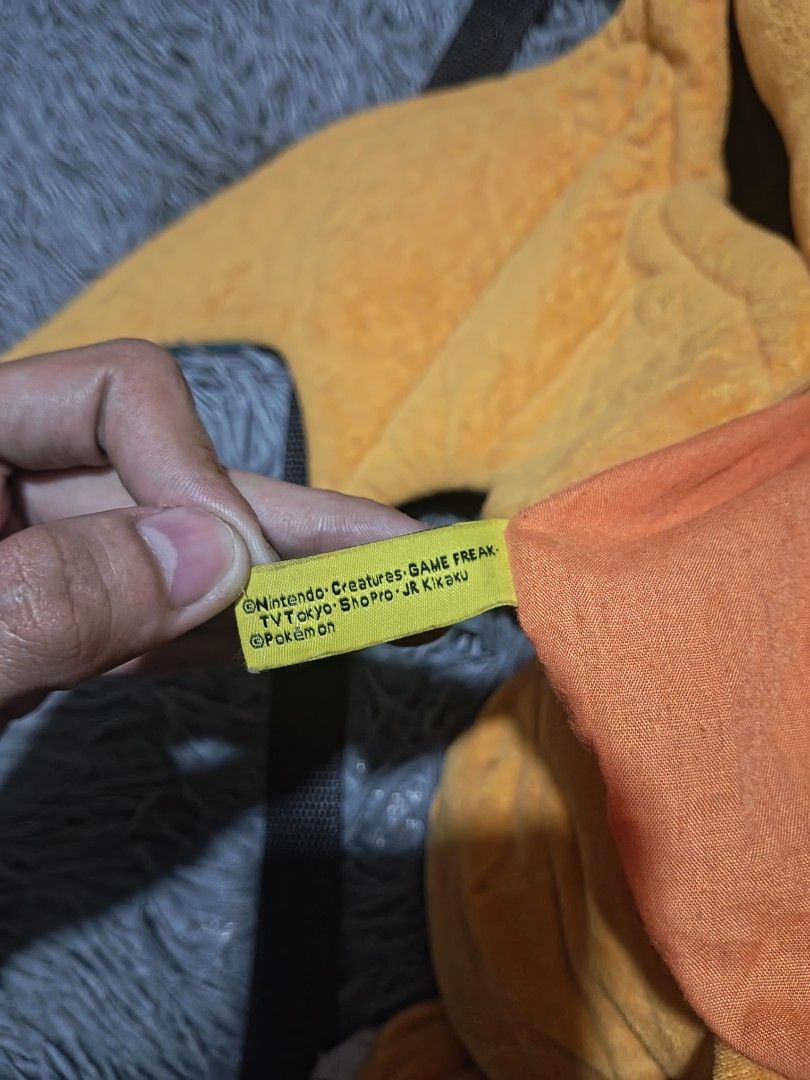Pokemon Charizard plush backpack (Category: Backpacks) located in Calamba. Submitted by fitzz.kiyann (Listing ID 1454174129, Image 3). Description: Pokemon Charizard plush backpack heavy cotton large staff toy small pocket at the back length 27 width 24 issues: non.