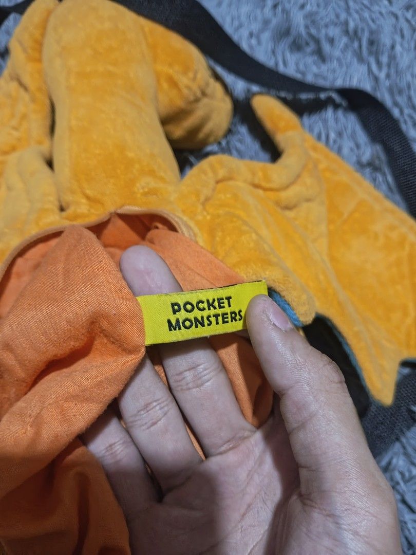 Pokemon Charizard plush backpack (Category: Backpacks) located in Calamba. Submitted by fitzz.kiyann (Listing ID 1454174129, Image 2). Description: Pokemon Charizard plush backpack heavy cotton large staff toy small pocket at the back length 27 width 24 issues: non.