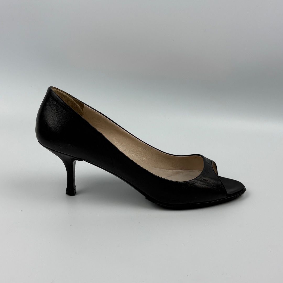 Prada Black Leather Peep-Toe Kitten Heels (Category: Heels) located in Enrique B. Magalona (Saravia). Submitted by artisan.ph (Listing ID 1454160538, Image 2). Description: - Classic black Prada heels - Peep-toe design - Comfortable kitten heel - Made from textured leather - Size 37 - Versatile for everyday or special occasions.