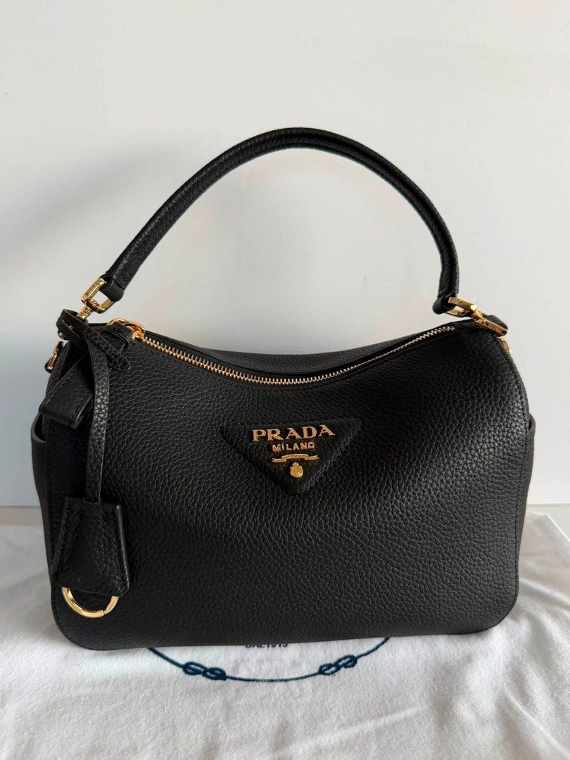 Preloved Prada Leather Handbag (Category: Luxury Bags & Wallets) located in Manila. Submitted by bagsandshoesmanymore (Listing ID 1434187496, Image 1). Description: - Authentic Prada handbag -Size 24cm -RiRi zipper - Top handle and detachable shoulder strap - Gold-tone hardware - Prada-branded interior lining - Interior zippered pocket - Prada logo on fronts Please read before you order 👉🏻❗️Payment first before shipping ❗️Cut off time of paymen
